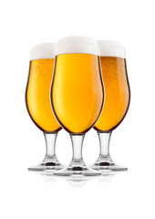 Cold glasses of lager beer with foam and dew