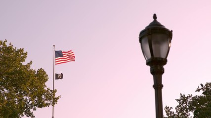 American Flag and POW flag flying in wind slow motion