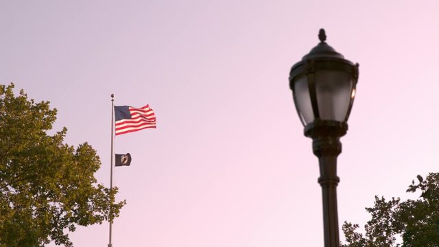 American Flag and POW flag flying in wind slow motion