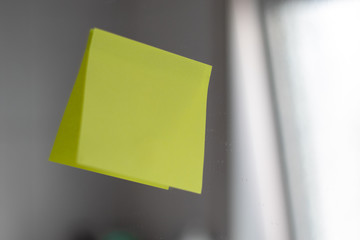 Close up of a yellow note at the mirror