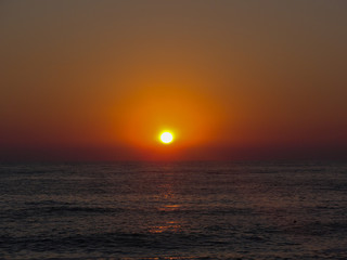 Beautiful red sunset. Natural Sunset Sunrise .Bright Dramatic Sky And Dark Ground. Landscape Under Scenic Colorful Sky. 