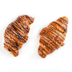 Two chocolate croissant on white background, top view