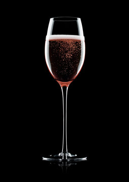 Rose pink champagne glass with bubbles on black