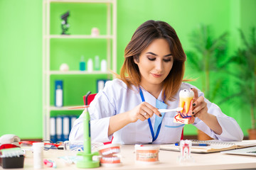 Woman dentist working on teeth implant