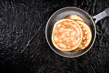 Pancakes on fry pan,dark slate,copy space