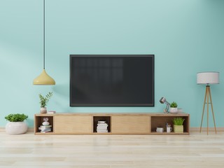 TV on cabinet in modern living room with lamp,table,flower and plant on blue wall background,3d rendering