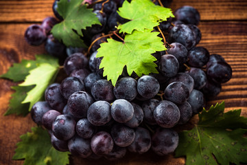 Puprle vine grapes on wooden table