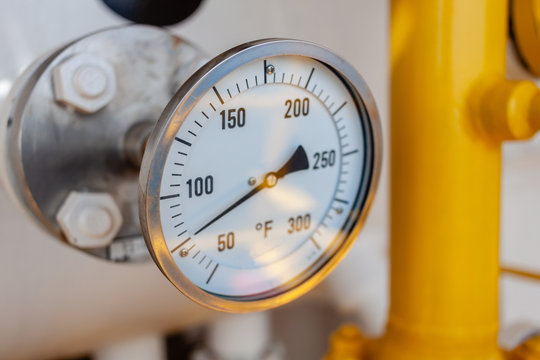 Thermometer, Temperature gauge or temperature indicator reading seventy five Fahrenheit (°F) in offshore oil and gas refinery process operation industry.