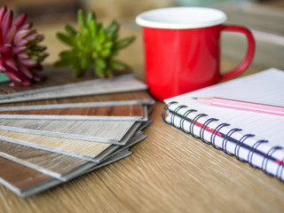 stack of click lock vinyl floor tiles sample on vinyl shop desk