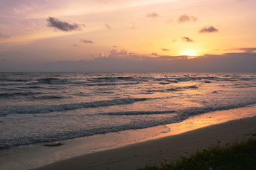 landscape of sea and water surf to beach in sunset