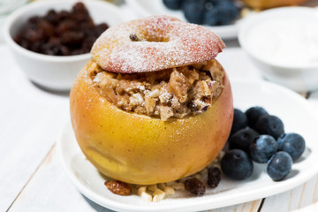 healthy breakfast. portioned oatmeal baked in apple, closeup
