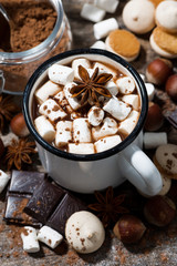 hot chocolate with marshmallows and sweets on wooden table, vertical top view