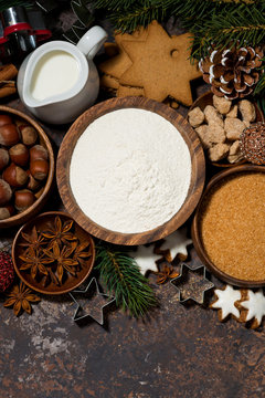 ingredients for Christmas baking on dark background, vertical top view
