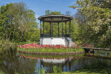 bridge with beautiful  park kiosk and tulips in Vondelpark in Amsterdam, Netherlands