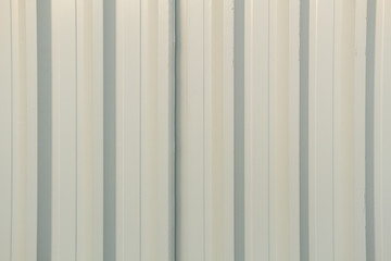 Textured metal wall in white color.