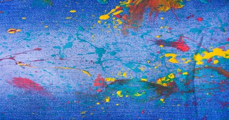 Denim, jeans texture background. Drops of colorful paint on blue background denim, jeans.