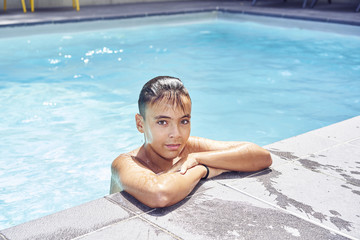 Boy with green eyes in the swimming pool