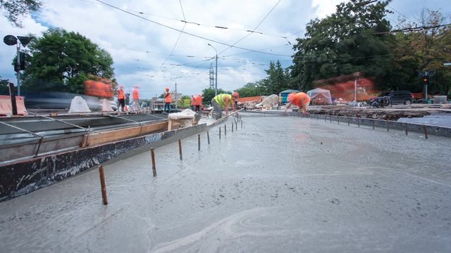Concrete works for road maintenance construction with many workers and mixer timelapse hyperlapse