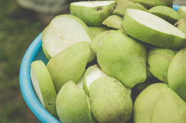 blue pailful of pears/pailful of the ripe cut pears, selective focus