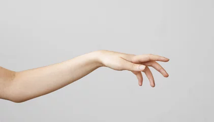 Fotobehang Female hand touching on gray background © sebra