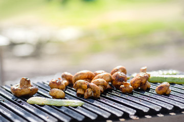 Closeup of delicious mushrooms barbecue roasted on metal grill