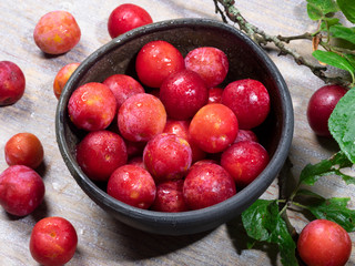 Rip ecologically grown plums in a bowl