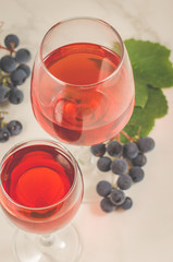 glasses of red wine and grape over white/glasses of red wine and grape, top view