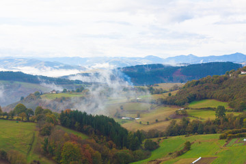 Fototapeta na wymiar Green hills and mountains in the fog in Tineo, Asturias, Spain