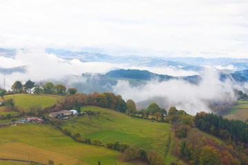 Green hills and mountains in the fog in Tineo, Asturias, Spain