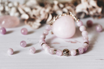 Bracelets made of natural stone and silver. Flat lay with lowers and accessories.