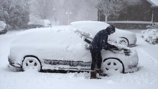 Man Shoveling Snow from Car