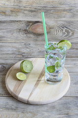 Lemonade with melissa leaves and a slice of lime. Rustic style