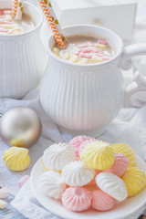 Cup of cacao with marshmallow, meringues and different Christmas decorations