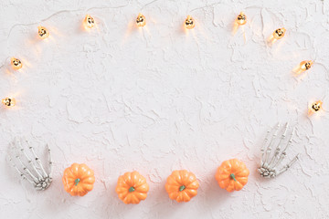 Halloween holiday background with Jack-o'-lantern Garlands on white table, flat lay and view from above