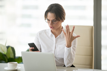Angry outraged businesswoman annoyed with missed call or no signal on stuck not working mobile...