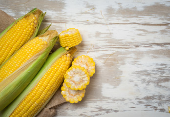 Fresh yellow sweet corn on wooden,top view