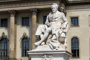 Fototapeta na wymiar Alexander von Humboldt statue outside Humboldt University from 1883 by Reinhold Begas, Berlin, Germany, sunny day