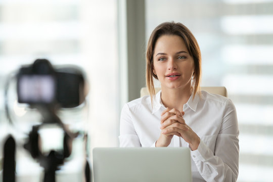 Successful businesswoman vlogger coach talking to camera filming live video blog or vlog giving business class presentation training teaching people online, blogger makes videoblog, vlogging concept