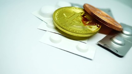 Bitcoin gold coin with bitcoin copper coin and pills blister, in rotating view. White background - Powered by Adobe