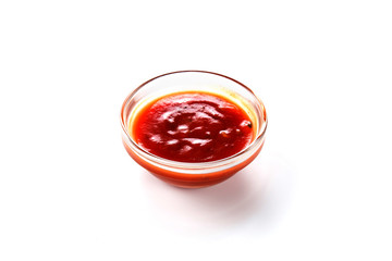 Sauce in a glass bowl on white background (close up)