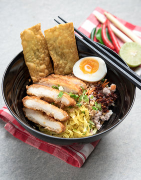 Thai spicy noodle,Thai yellow noodle tom yum with fried chicken and egg