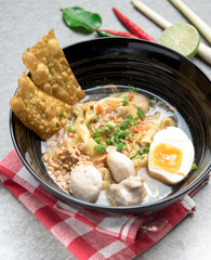 Thai spicy noodle,Thai yellow noodle tom yum with pork,egg and meat ball