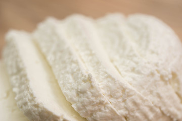 sliced white cottage cheese on wooden cutting board
