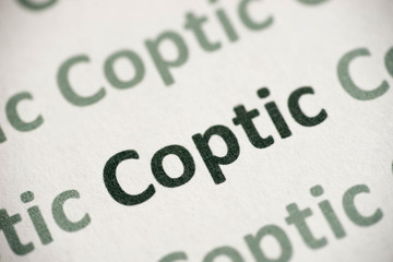 word Coptic language printed on paper macro