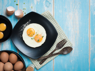 Fried eggs in a plate on a table,top view