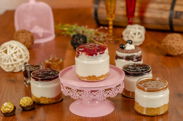 Obraz na płótnie Canvas cheesecake in a jar with Caramel,Strawberry,Blueberry,Raspberry