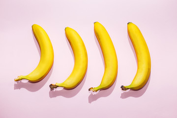 Bananas on pink pastel background. minimal idea food concept