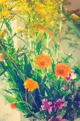 Bouquet of different wildflowers. Close-up, toning in the style of instagram.