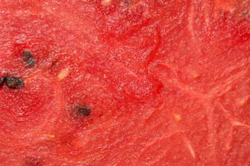 A saturated texture of red juicy fresh watermelon close-up