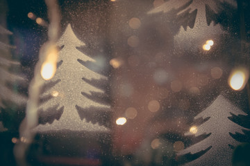 Blue toned blurred chrismas background  with Christmas trees  and street lights in vintage style
